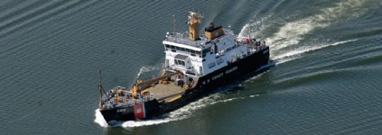 U.S. Coast Guard Cutter Fir (WLB 213) and lighthouse